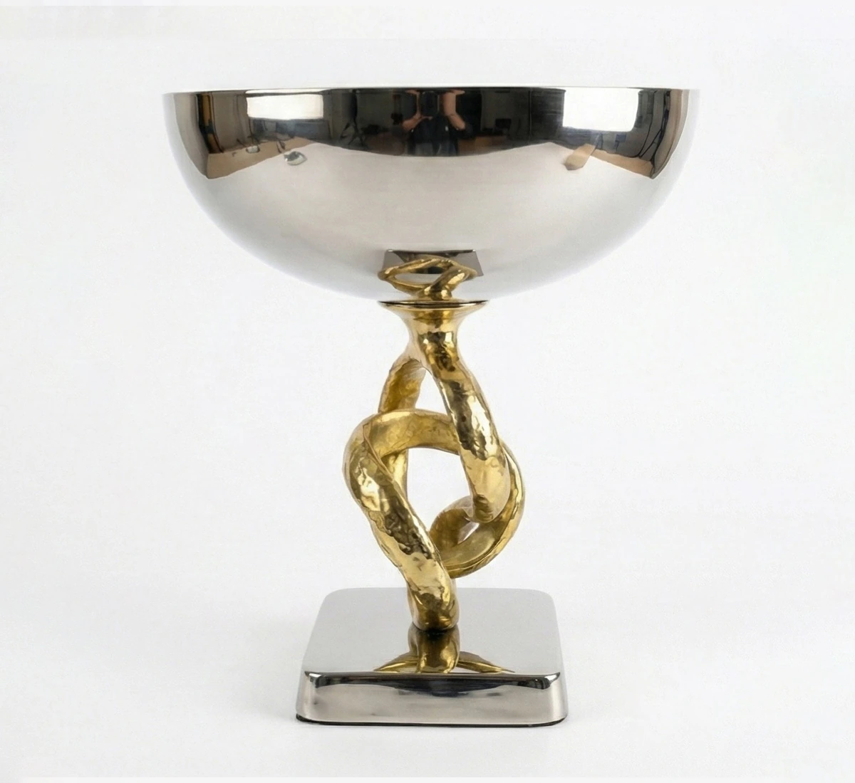 Close up detail of textured gold twisted rings stem on metal bowl