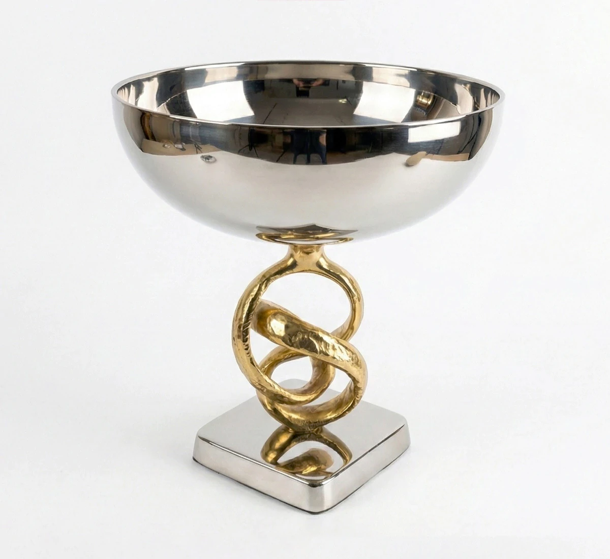 Front view of silver metal bowl with gold twisted ring stand on white background