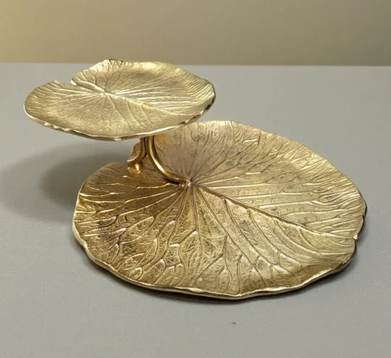 Luxury gold 2-tier stand shaped like textured lotus leaves.