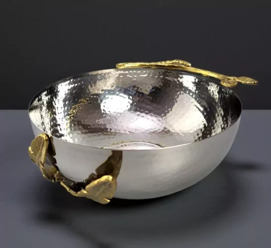Hammered silver metal bowl with decorative gold leaf branch accents.