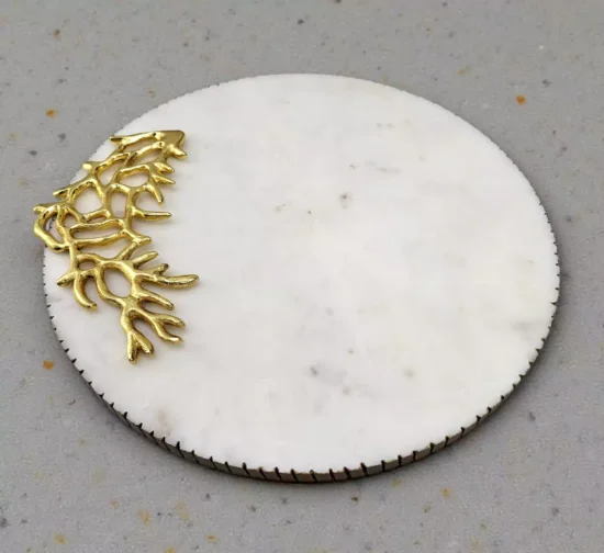Round white marble serving board with reeded edge and gold aluminum coral decoration