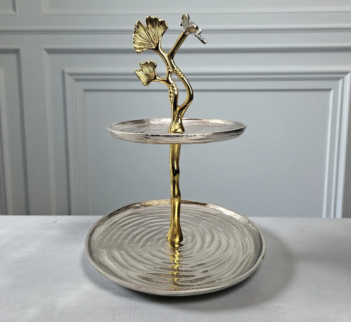 Mixed metal 2-tier serving stand with silver ripple trays and gold ginkgo leaf handle.