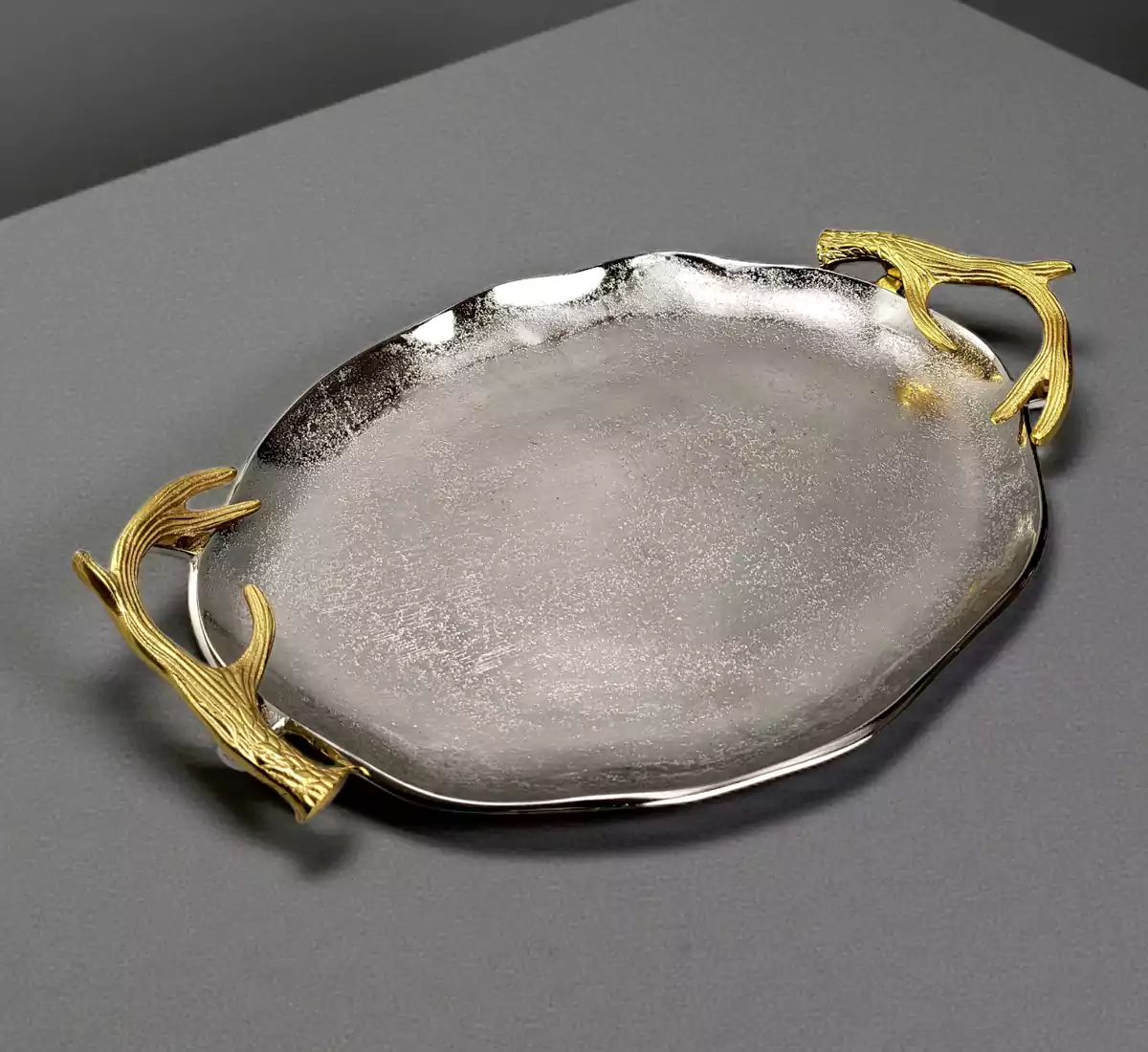 Oval silver metal serving tray with gold stag horn handles.