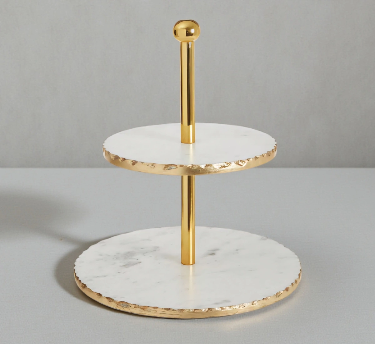 Luxury white marble 2-tier serving stand with gold rough edges.
