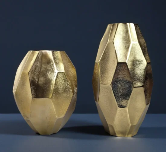 Pair of modern gold vases with geometric diamond-cut faceted design.